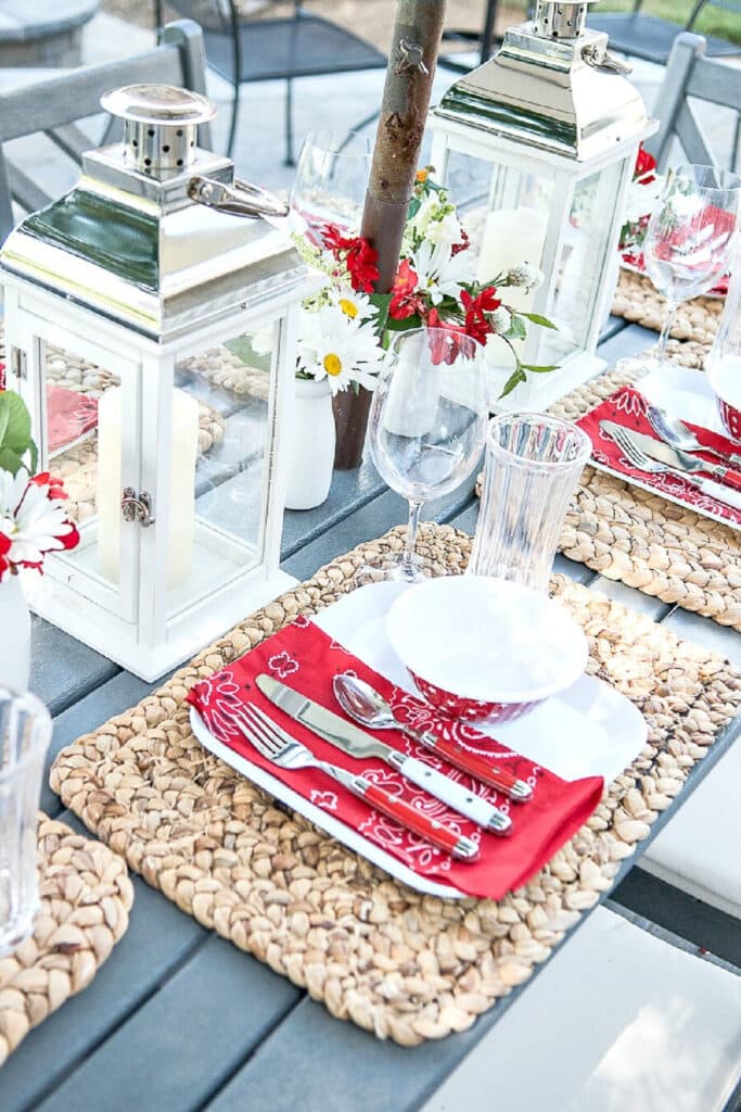 SUMMER TABLE SET OUTDOORS WITH RED AND WHITE MELAMINE DISHES