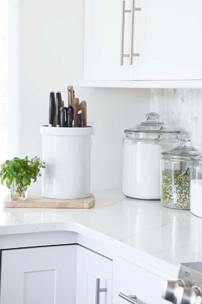 glass canisters on kitchen counter storing dry goods for organized kitchen storage