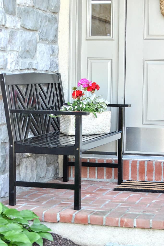 BLACK BENCH ON A FRONT PORCH