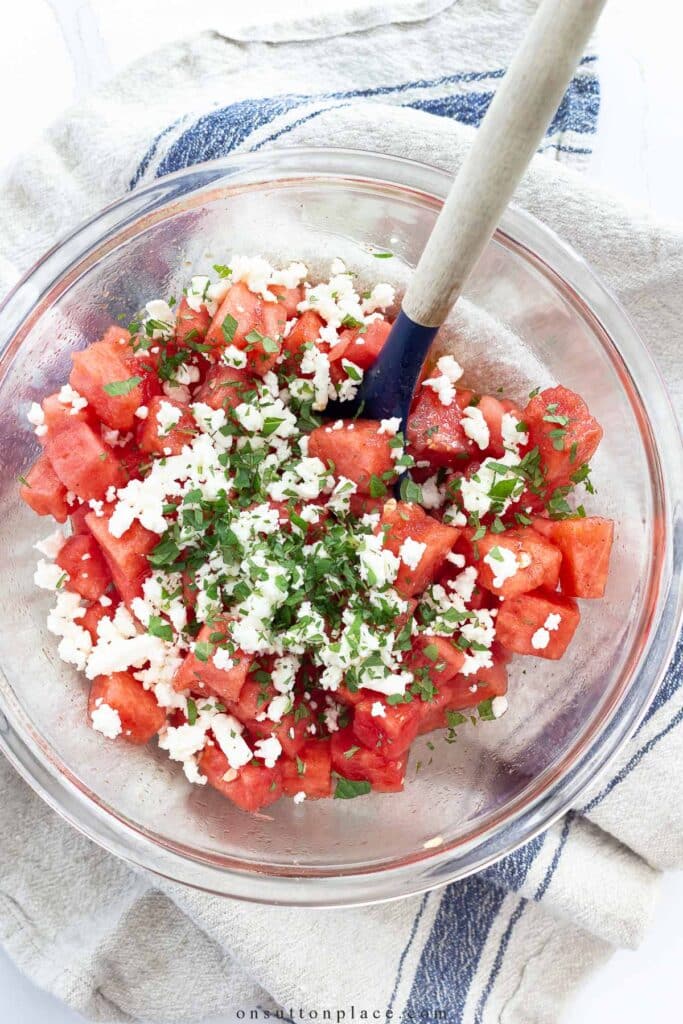 Watermelon salad in a clear mixing bowl