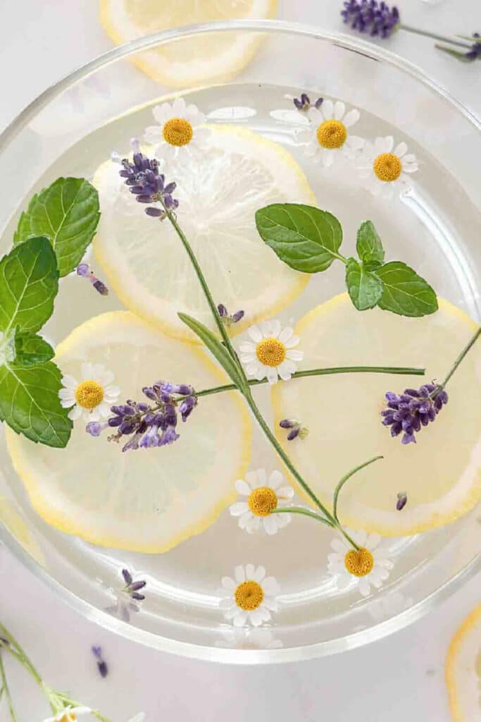 summer simmer pot filled with fresh lemons, mint, lavender and feverfew flowers.