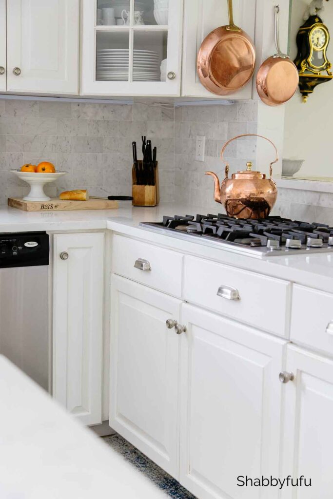 white kitchen with copper accents