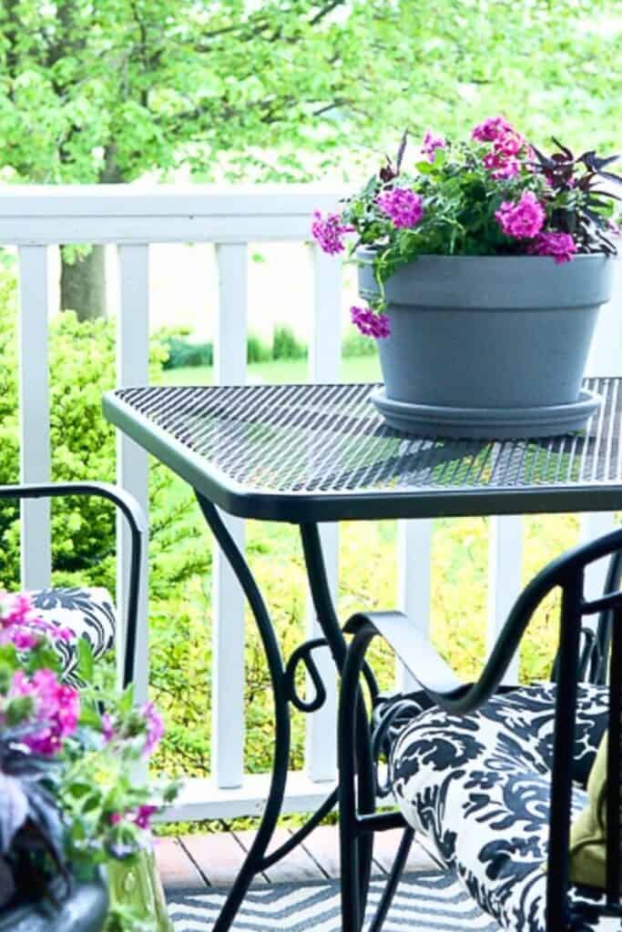 I hope these 60+ summer patio ideas have you feeling inspired and excited to get outside and enjoy your outdoor space this season! Whether you have a sprawling backyard patio or a cozy little covered space like mine, the most important thing is that you make it yours and actually spend time there.
One of the things I want to encourage you to do this summer is to simply enjoy the season by spending time on your porch or patio. Life moves so fast, and sometimes the most restorative thing you can do is just sit outside and breathe it all in. My favorite time is in the evening, when the day winds down and I can relax, read, and watch the golfers go by. It is such a simple pleasure, but it is one of my very favorite things about summer.
You do not need a big budget or a big space to create a patio you absolutely love. A string of lights, a few beautiful planters, a comfortable chair, and a good cup of something cold are really all you need.
So get out there, friend. Your summer patio is waiting!
If you try any of these ideas I would love to hear about it in the comments below. And if you have a summer patio idea that I did not include, please share it!