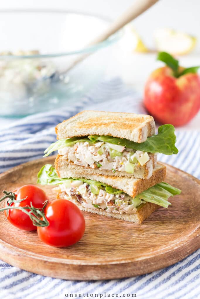 chicken salad sandwich on a wooden round