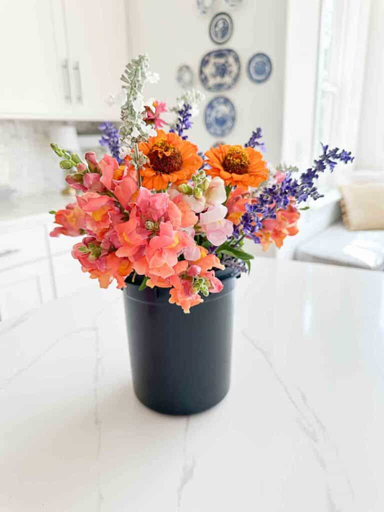 conditioning flowers in a black bucket