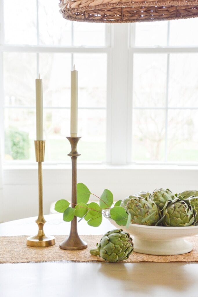 dining table centerpiece ideas using artichokes candles and simple organic decor