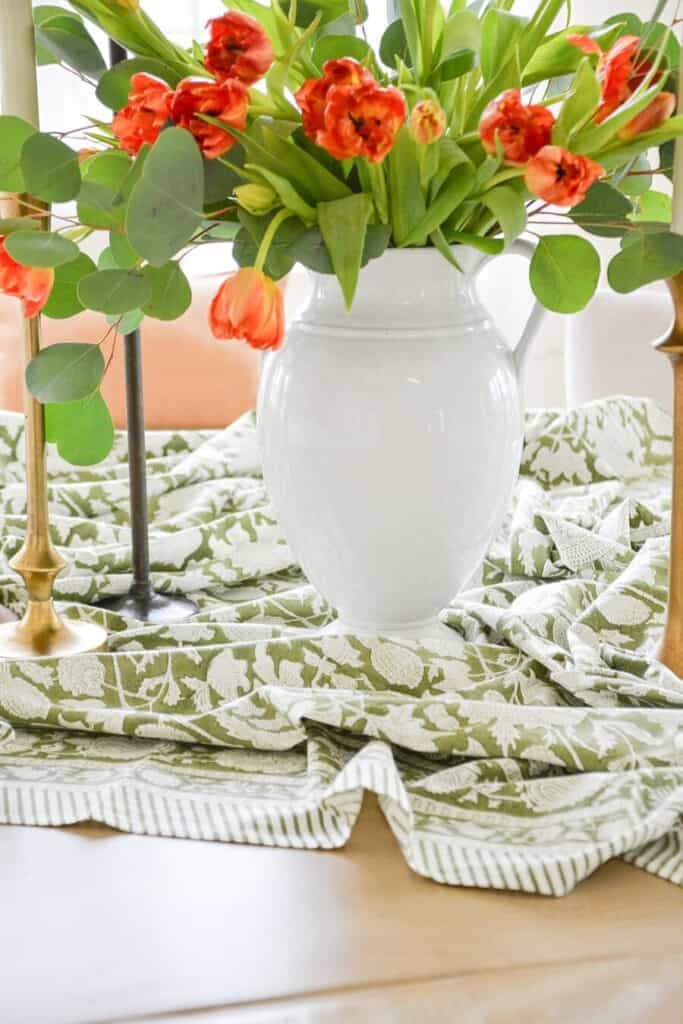 dining table centerpiece ideas using layered textiles flowers and candles for a relaxed look