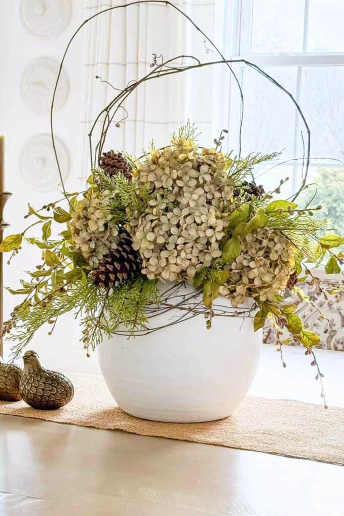 dining table centerpiece ideas with hydrangeas greenery and branches in a white vase