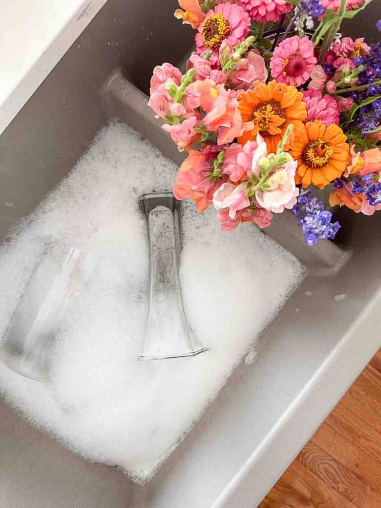 glass vases in sudsy water