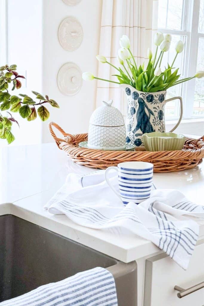 simple kitchen ideas using a tray with blue and white decor, tulips, and kitchen accessories on a white countertop