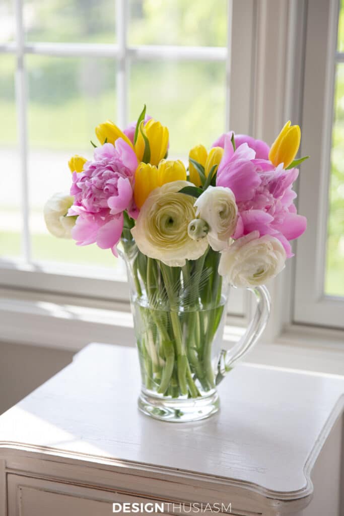 mixed flowers in a clear pitcher