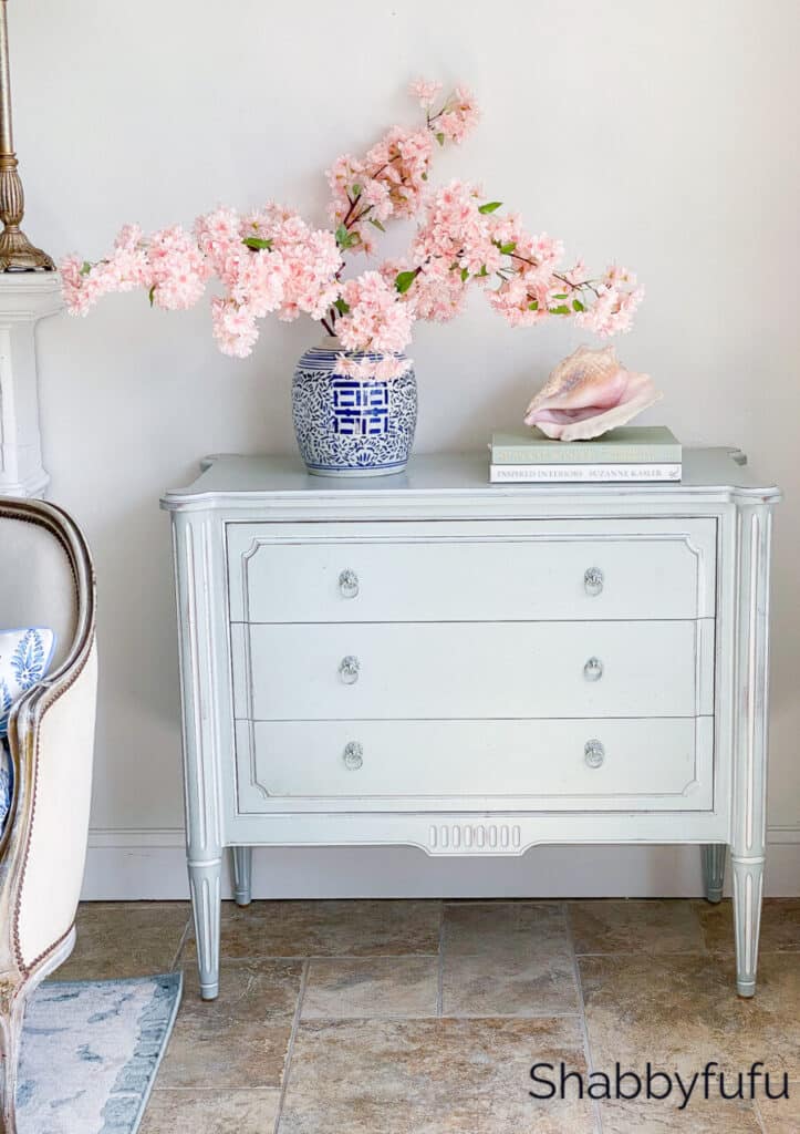 minimal summer decor on a living room chest