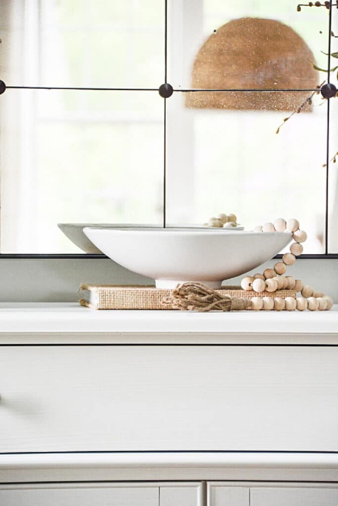 WHITE BOWL WITH WOODEN BEADS EXAMPLE OF NEGATIVE SPACE- SCALE AND PROPORTION