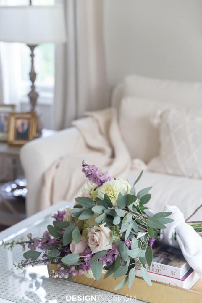 a bouquet of roses and other flowers on a coffee table