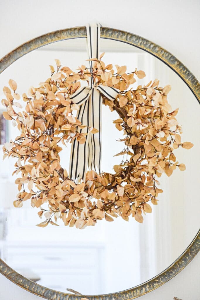 early fall leaf wreath hanging on a mirror