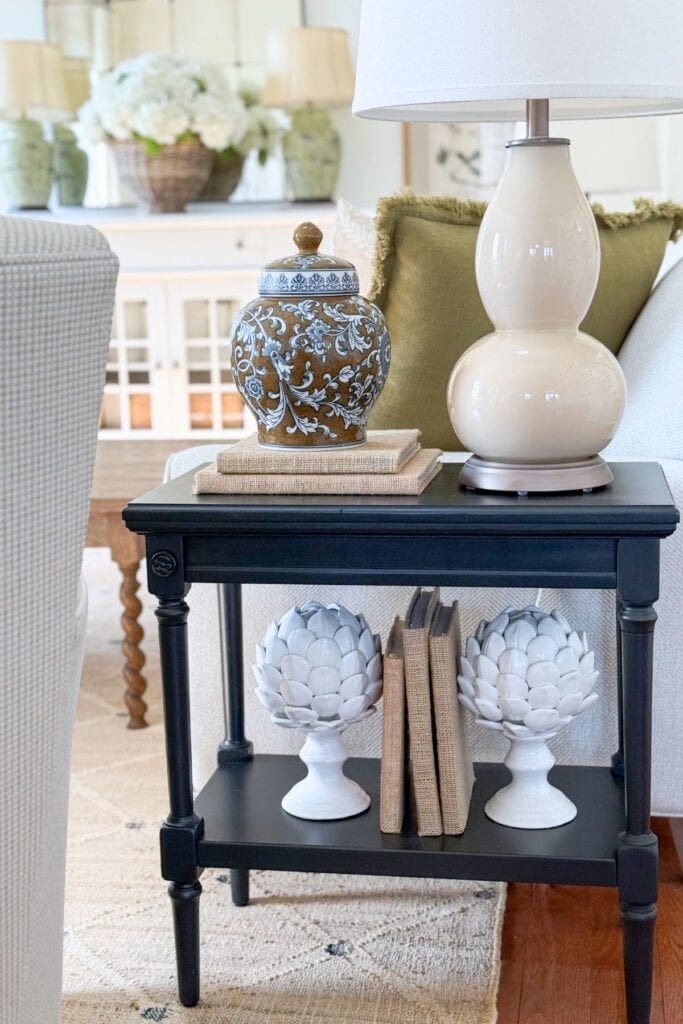 Neutral home decor vignettes with brown patterned vases and white lamps on books for a cohesive look