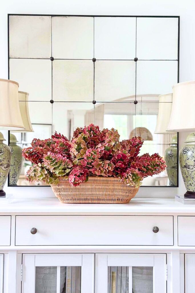 t tag
Pink and green hydrangeas in a woven basket on a console for late summer decorating