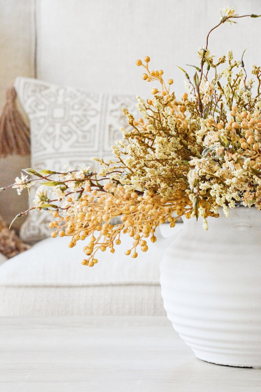 dried flowers in a white vase