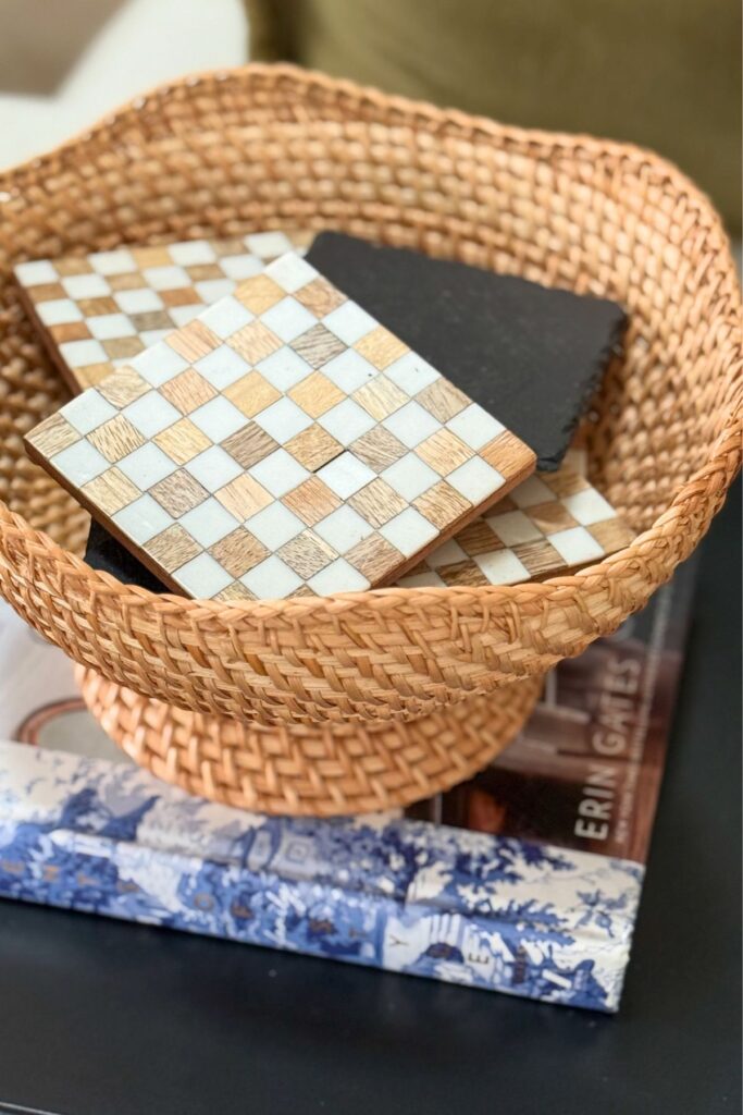 Checkerboard coasters styled in a wicker tray for late summer decorating