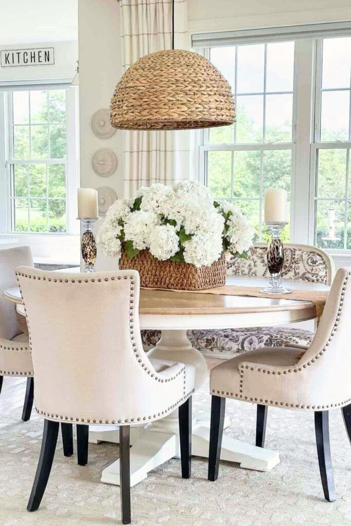 Round dining table set with a floral centerpiece and no clutter