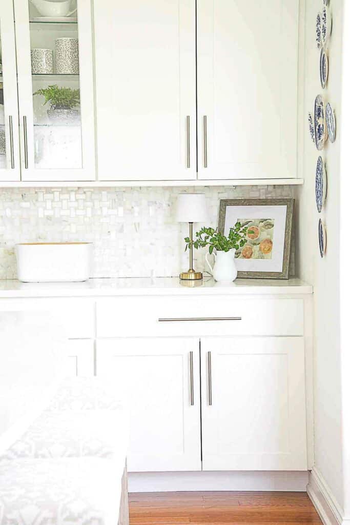 ART PROPPED UP IN THE CORNER OF A KITCHEN COUNTER