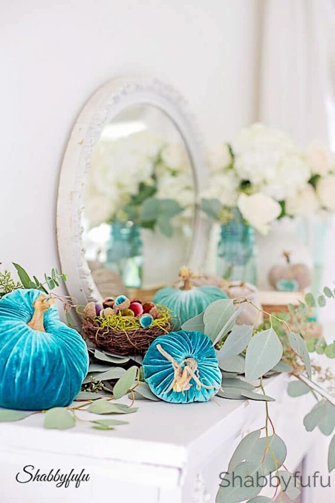 aqua velvet pumpkins on a mantel