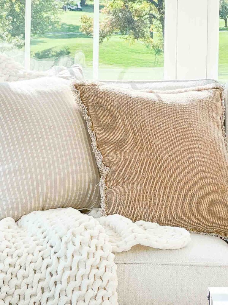 FALL PILLOWS AND A CHUNKY THROW ON A SOFA