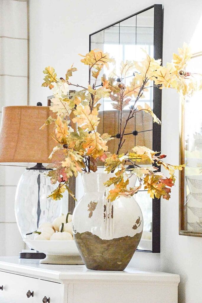PLANNING FOR FALL DECORATING:Urn of fall leaves on the white buffet- hero