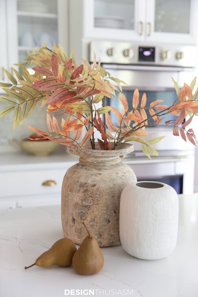 container of fall leaves on a kitchen counter