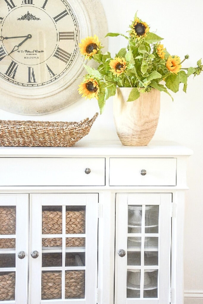 faux sunflowers in a wooden vase
