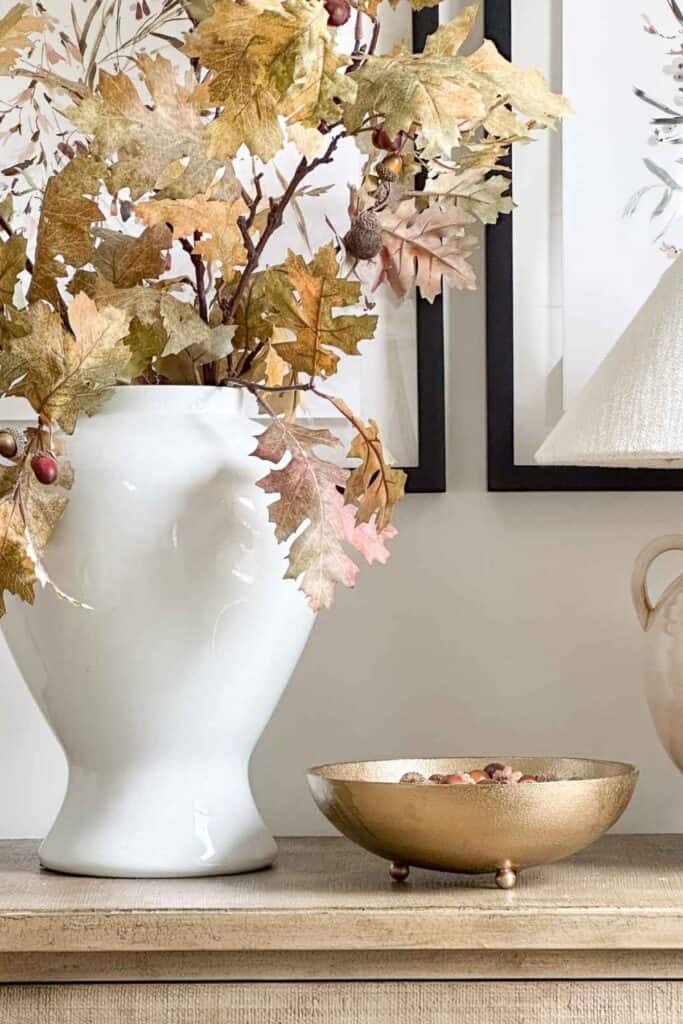 gold bowl of acorns sitting on a chest