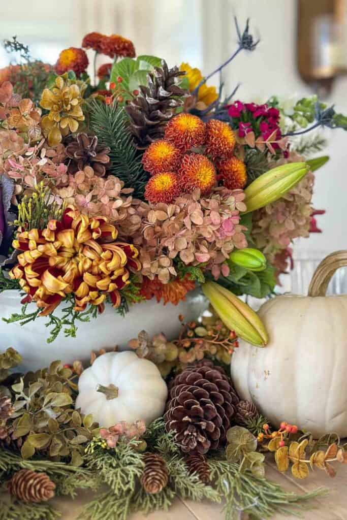 orange lit candle with ornamental cabbages on a gold tray