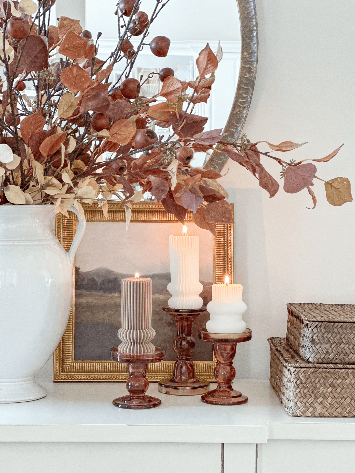 fall candles and leaves on a white foyer table
