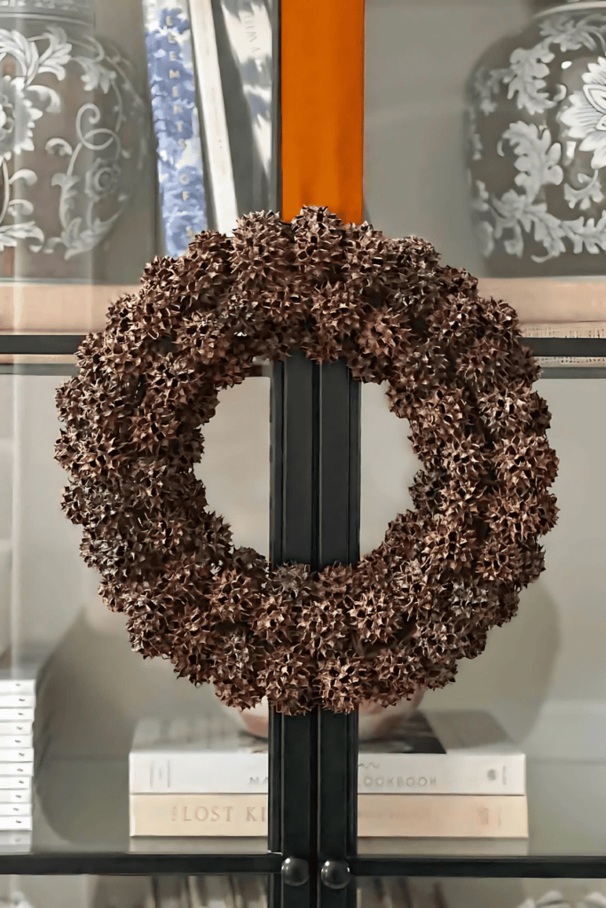 SWEET GUM BALL WREATH HANGING ON A COPPER RIBBON