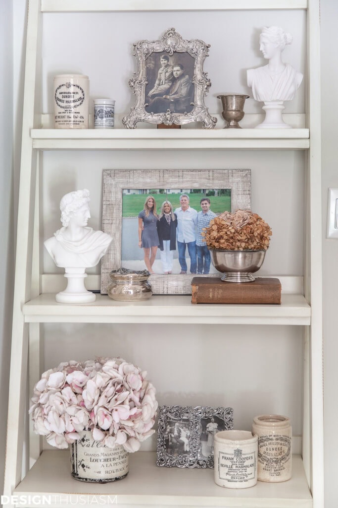 white shelf with family pictures