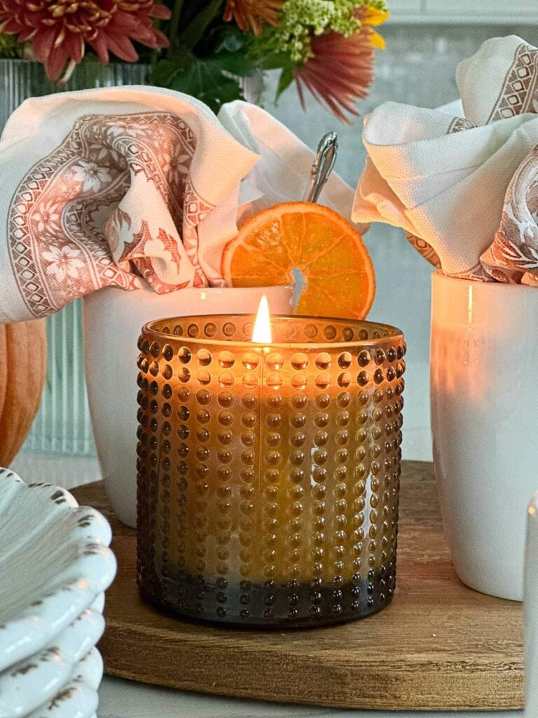 cande in a brown glass container on a fall coffee bar.