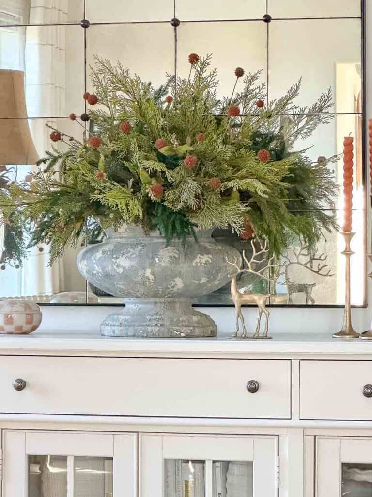 large arrangements of greens in a gray urn