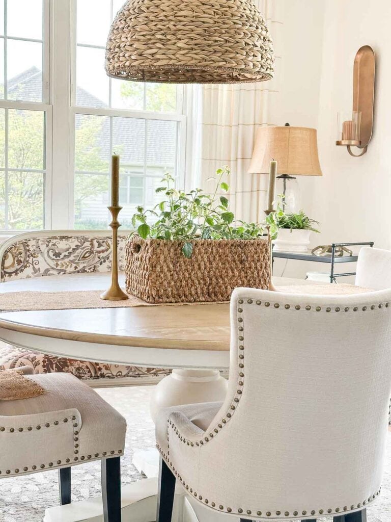 dining room table with a basket of ivy on a runner