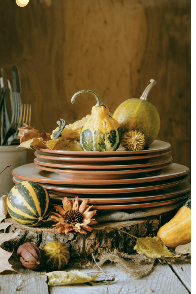 stack of dishes with gourds on the top
