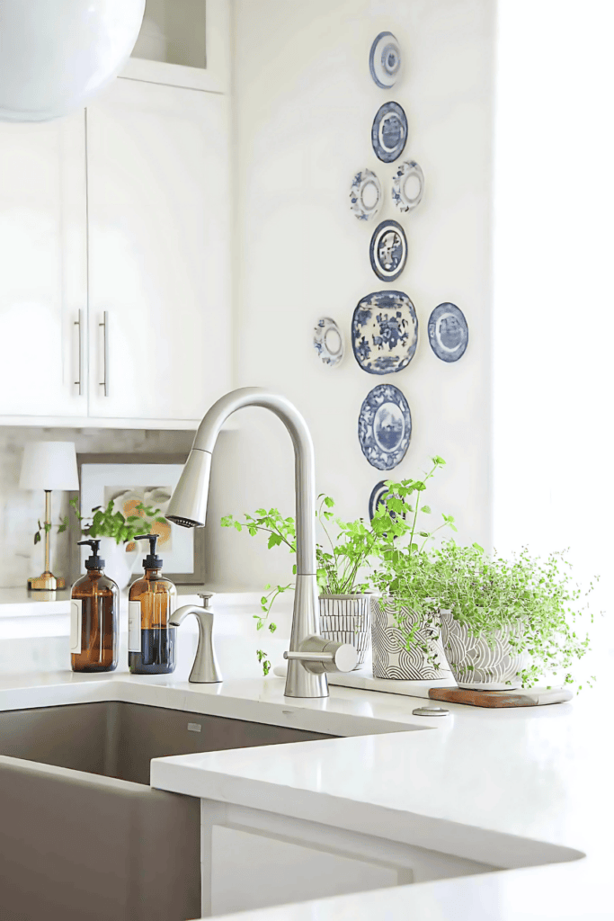 WHITE KITCHEN WITH HERBS IN POTS NEAR A SINK