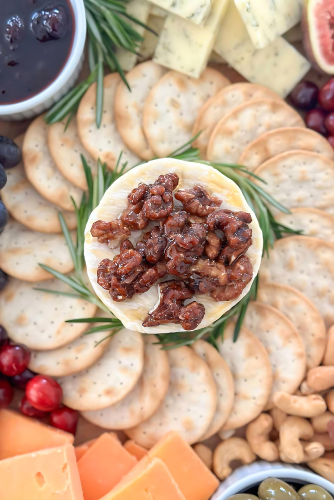 walnuts and honey on a round of camembert on a holiday charcuterie board.