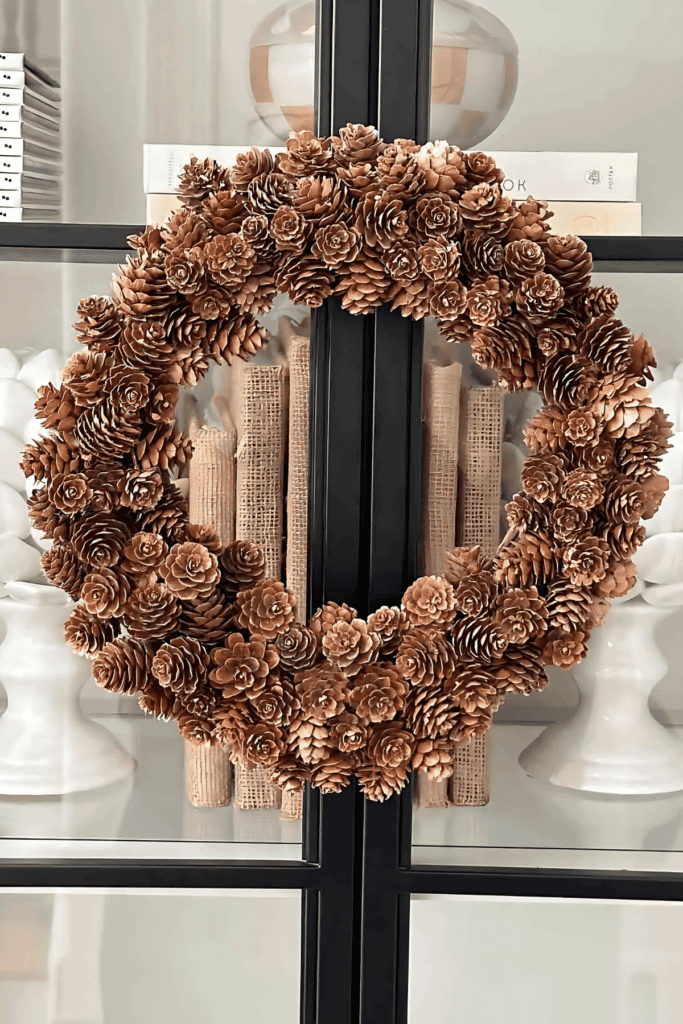 MINI PINECONE WREATH ON A GLASS DOOR
