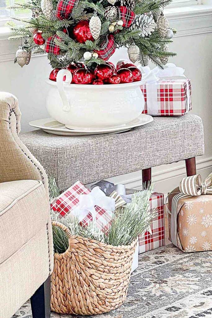 Christmas presents under a tabletop tree in a small room