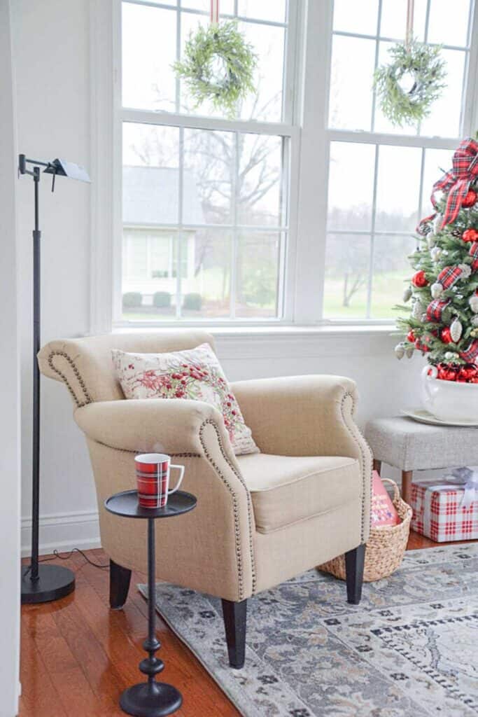 chair with a Christmas pillow in a small room