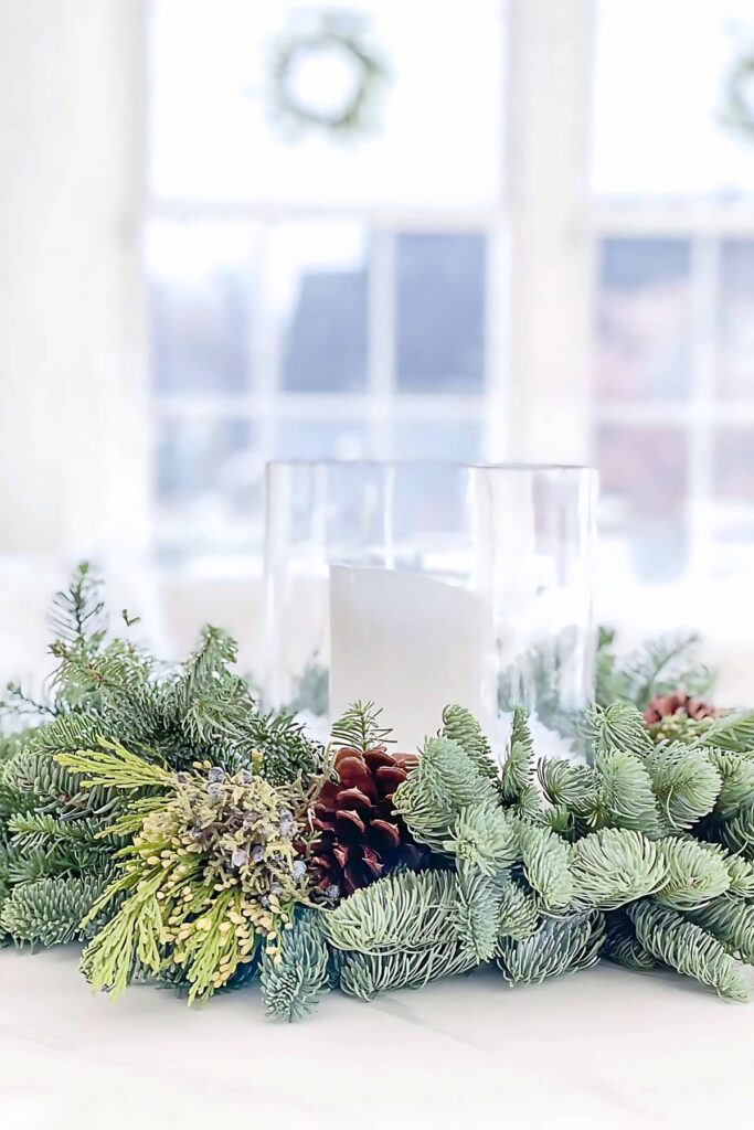Christmas greens around a white candle