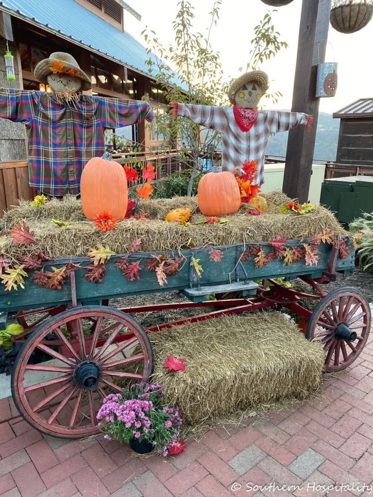 fall wagon with pumpkins and scarecrows