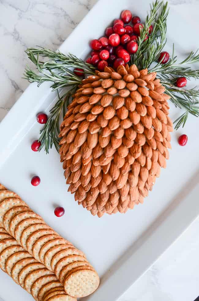 pinecone cheese ball on a white platter