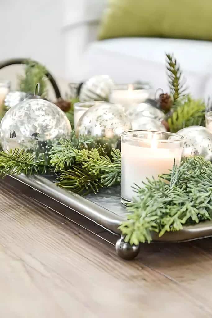 greens, Christmas balls and candles in a tray