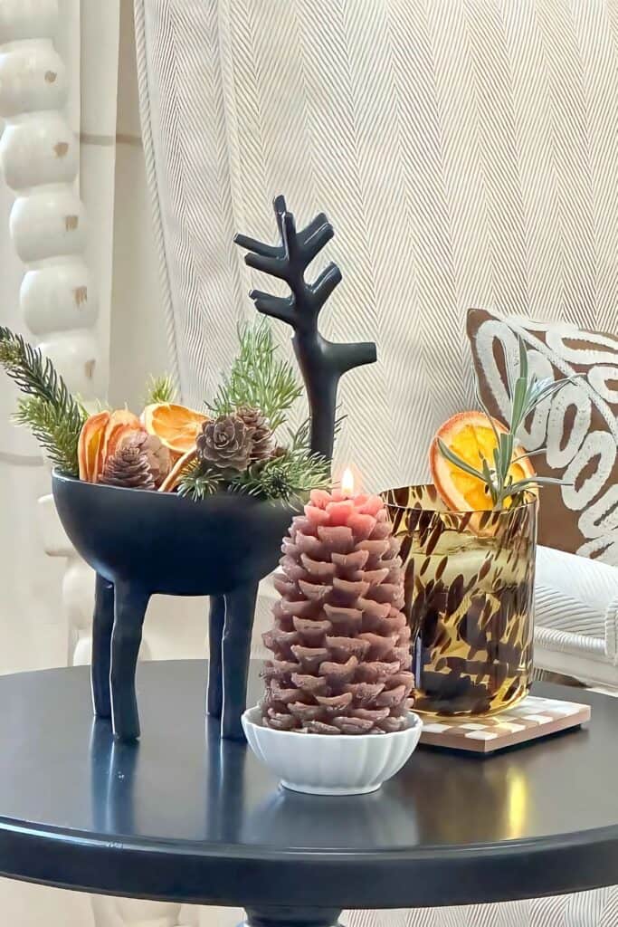 trio of Christmas items and a libation on a drink table