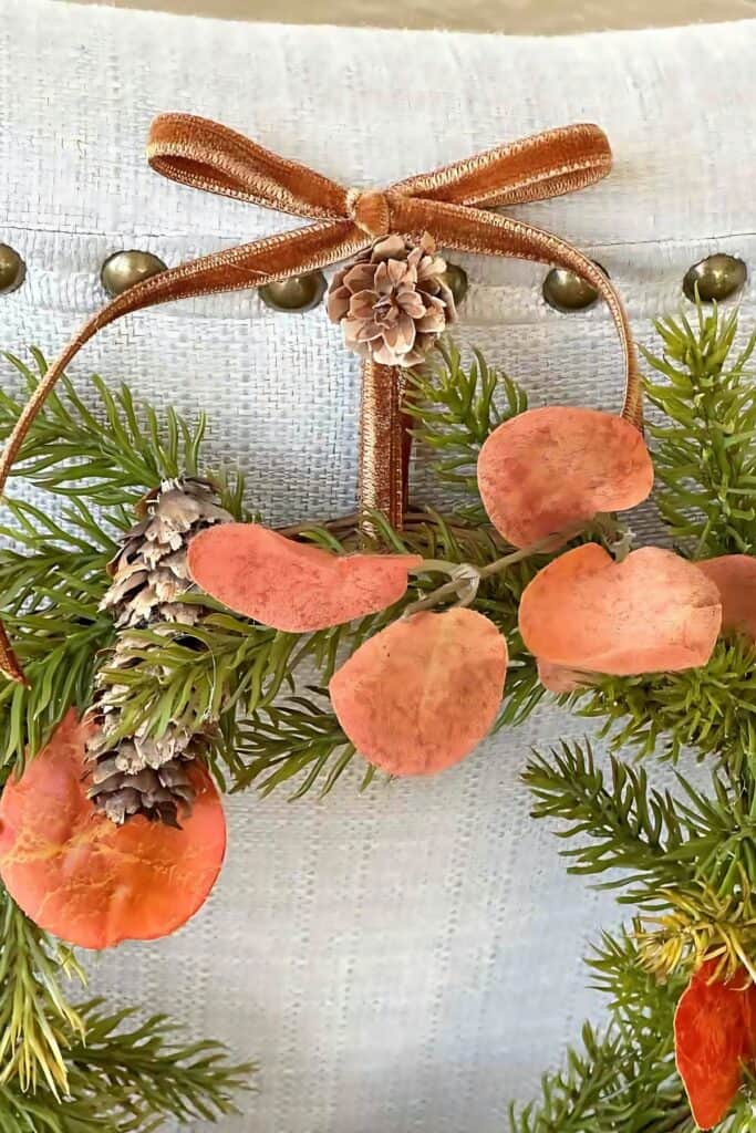 pinecone and bow holding up wreath